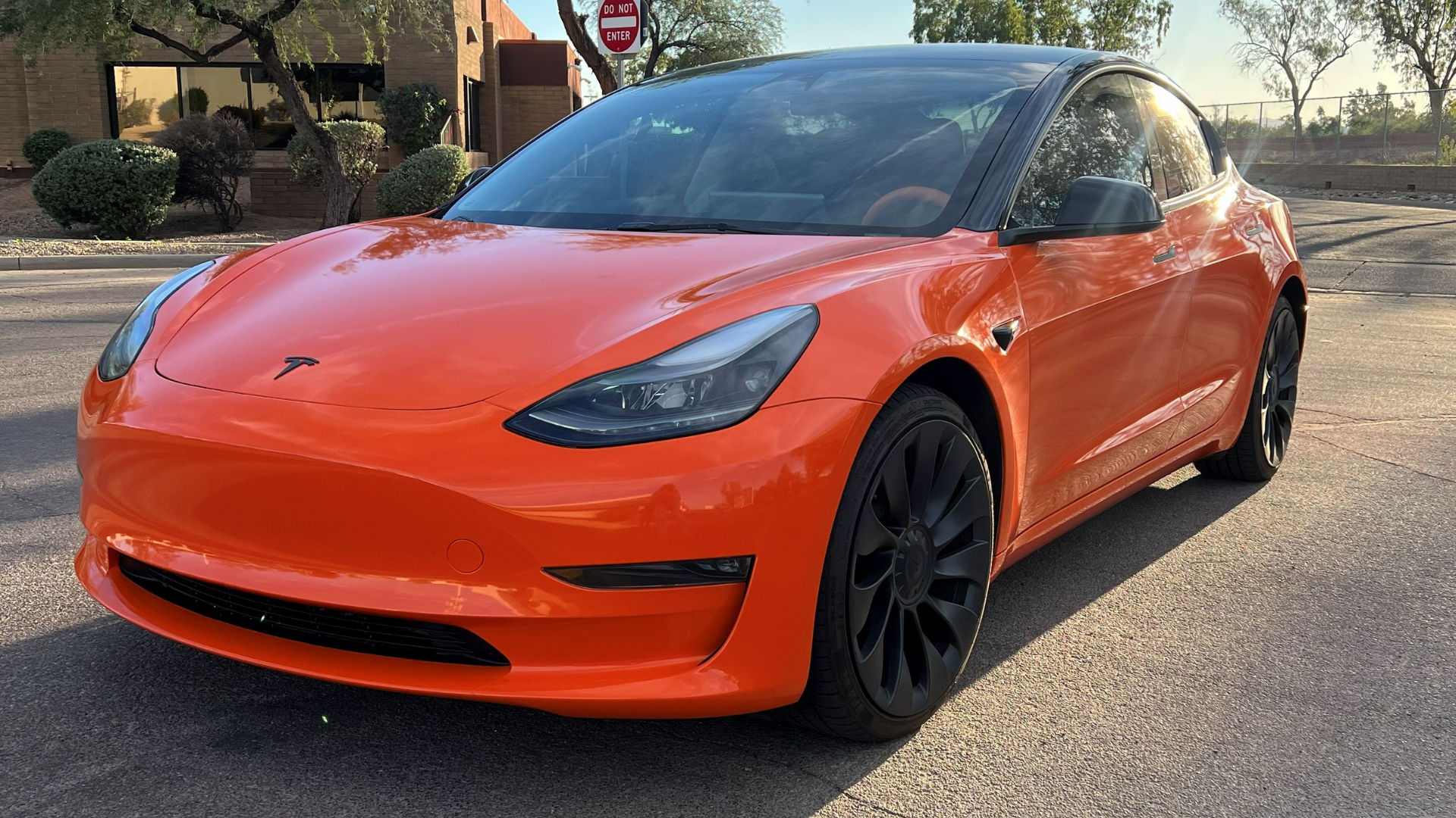 Gloss orange vinyl wrap on Tesla