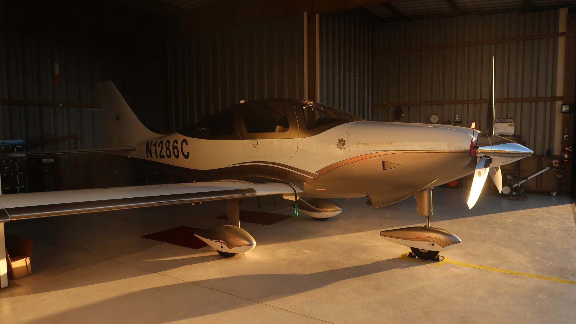 Columbia 400 single engine airplane with partial vinyl wrap in gold at Falcon Field Airport in Mesa AZ