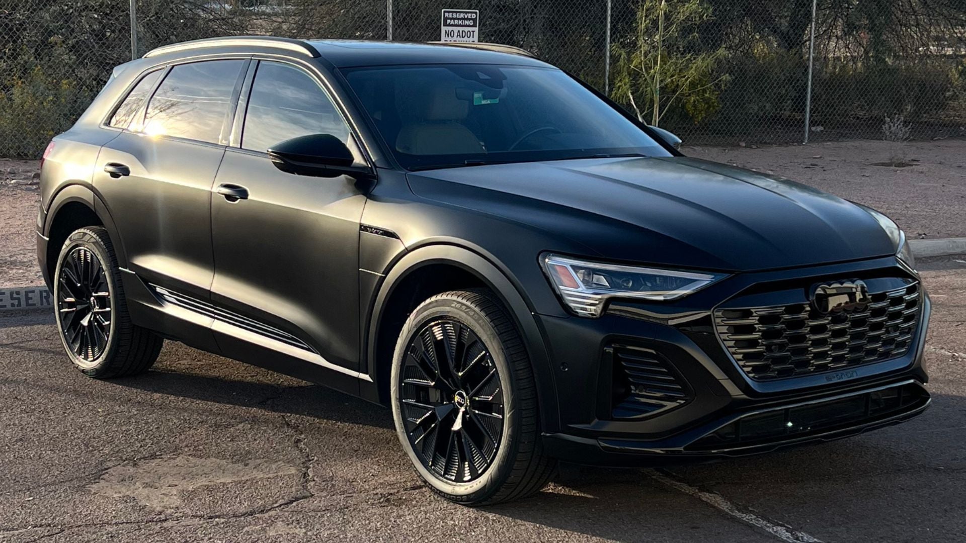 Audi with full color change wrap to satin black and gloss black accents parked outside during sunset in Scottsdale AZ