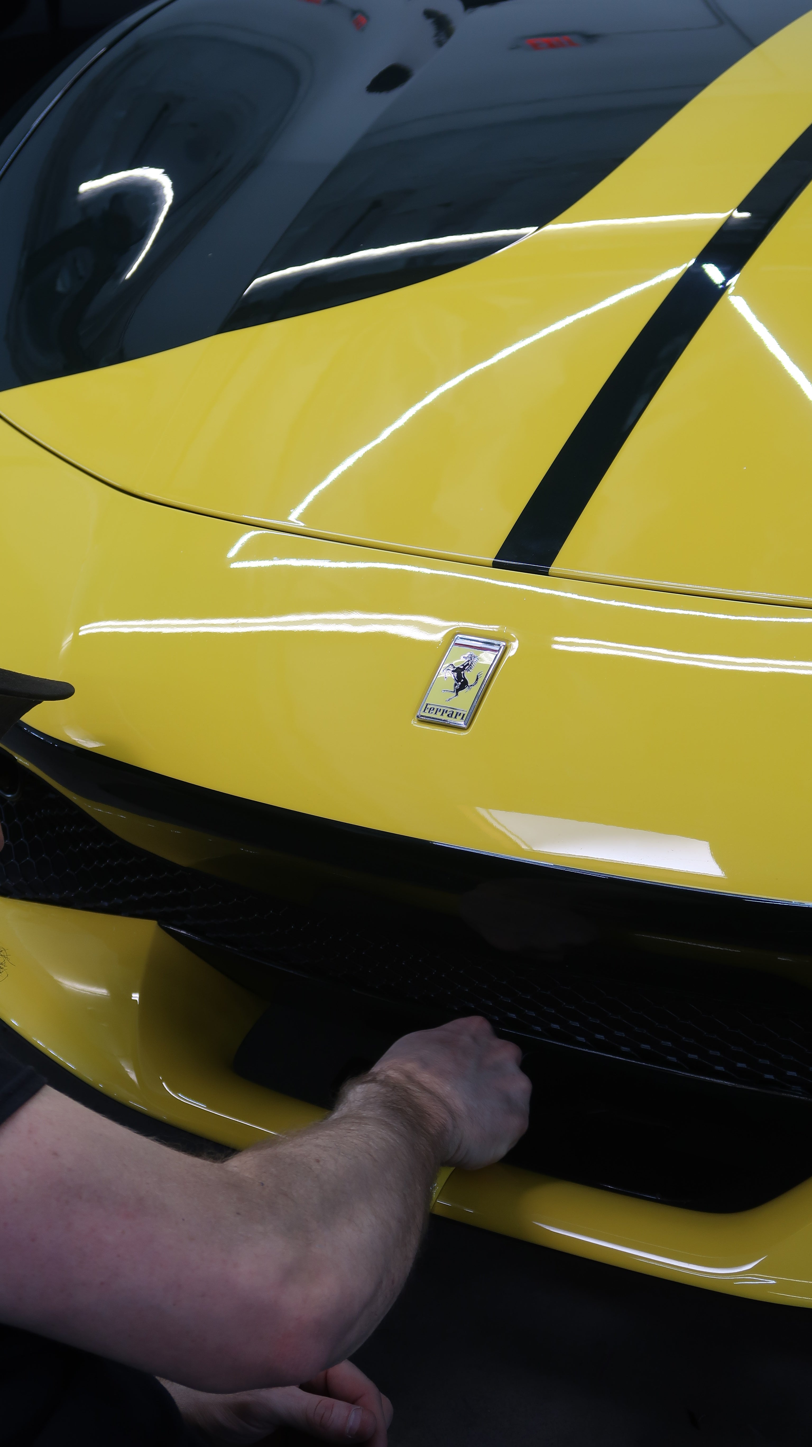 Yellow Ferrari with paint protection film (PPF) edge refinement and trim correction in Tempe AZ
