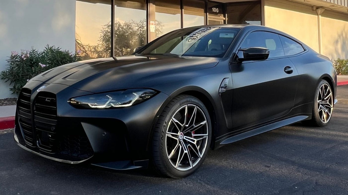 BMW wrapped in satin black with tinted headlights outside Innovated Wraps in Tempe, Arizona